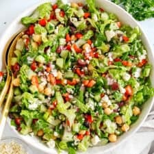Fresh and crisp Mediterranean Chopped Salad made with fresh tomatoes, crisp cucumbers, red onion, chickpeas, olives and feta cheese all tossed with a delicious red wine vinaigrette!