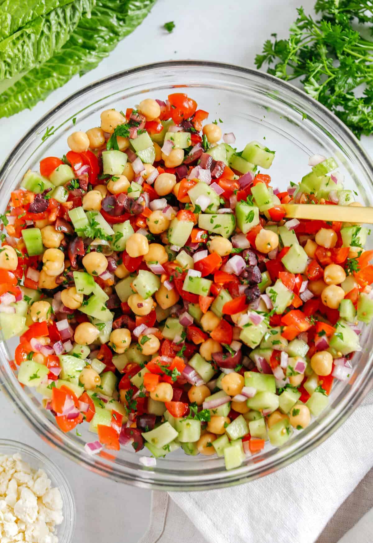 Fresh and crisp Mediterranean Chopped Salad made with fresh tomatoes, crisp cucumbers, red onion, chickpeas, olives and feta cheese all tossed with a delicious red wine vinaigrette!