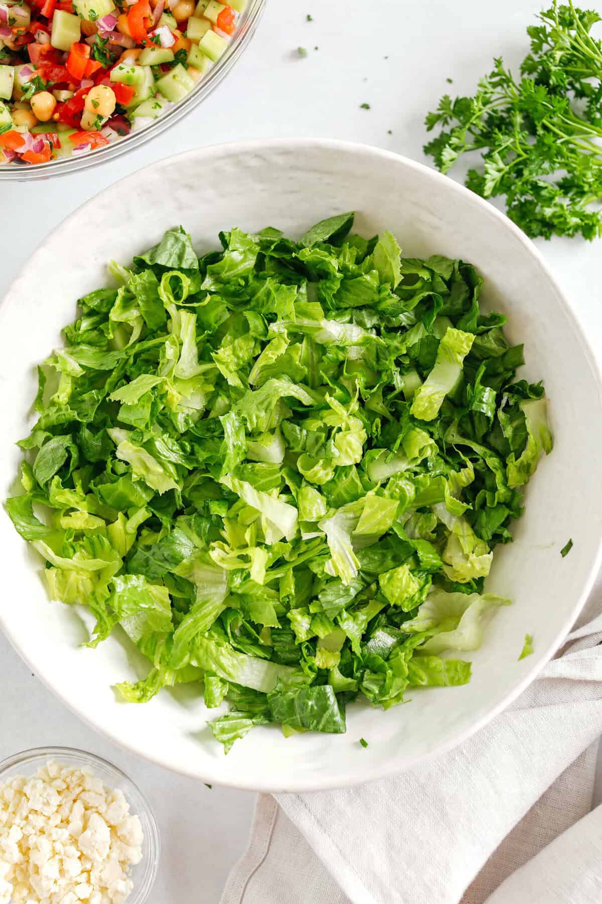 Fresh and crisp Mediterranean Chopped Salad made with fresh tomatoes, crisp cucumbers, red onion, chickpeas, olives and feta cheese all tossed with a delicious red wine vinaigrette!