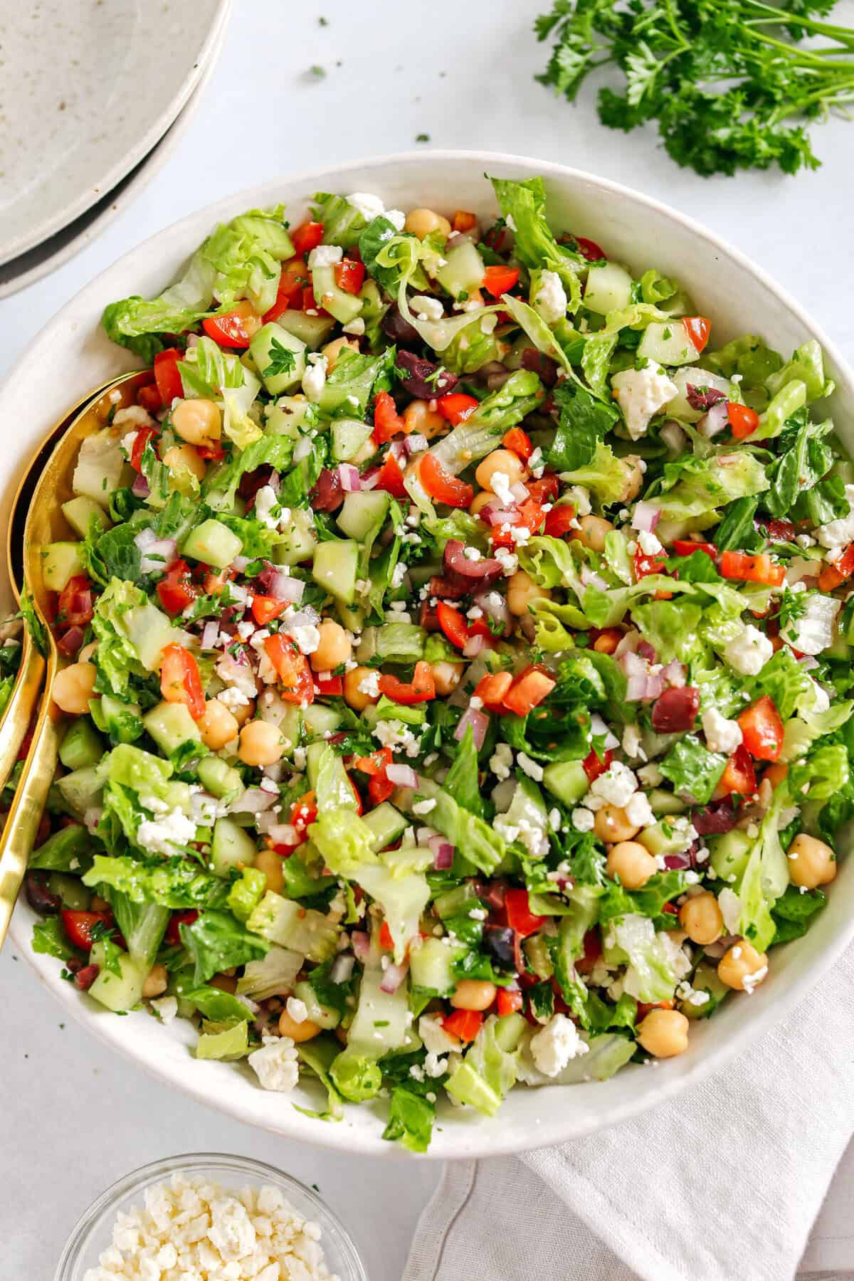 Fresh and crisp Mediterranean Chopped Salad made with fresh tomatoes, crisp cucumbers, red onion, chickpeas, olives and feta cheese all tossed with a delicious red wine vinaigrette!