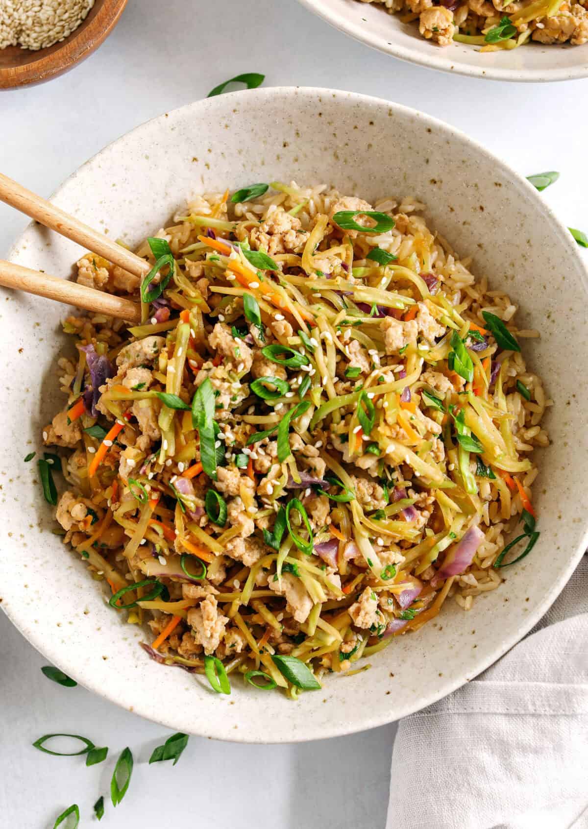 Easy and flavorful Chicken Egg Roll in a Bowl that comes together in under 20 minutes packed with so much flavor!ย Perfect healthy weeknight dinner served over rice and garnished with green onions and sesame seeds.