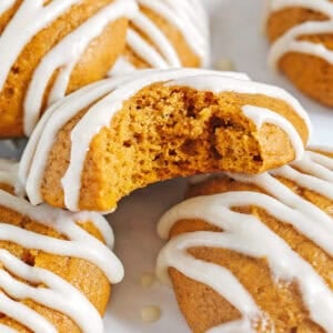 Pillowy soft Iced Pumpkin Cookies made healthier with whole wheat flour and zero butter or refined sugar all drizzled with a delicious maple cream cheese icing! These cake-like pumpkin cookies make the perfect fall treat to enjoy this season.