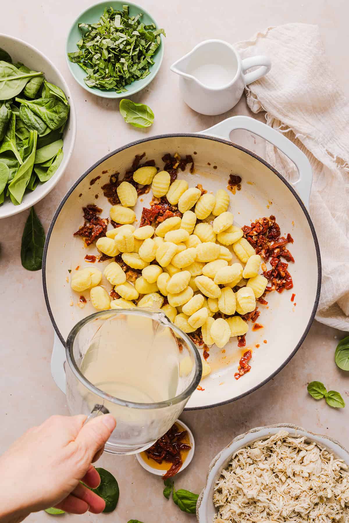 This EASY One Pan Marry Me Chicken and Gnocchi is the perfect weeknight meal! Pillowy soft gnocchi and tender chicken simmered together in a creamy sun dried tomato and parmesan sauce in just 20 minutes!  