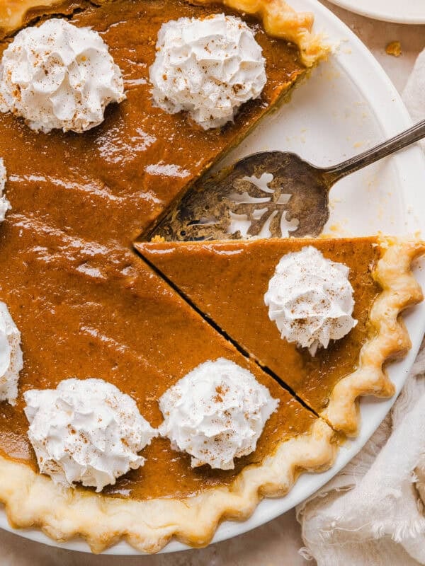 This creamy and delicious Healthy Pumpkin Pie makes the perfect holiday dessert! So easy to make, naturally sweetened with maple syrup and tastes great topped with whipped cream or vanilla ice cream!