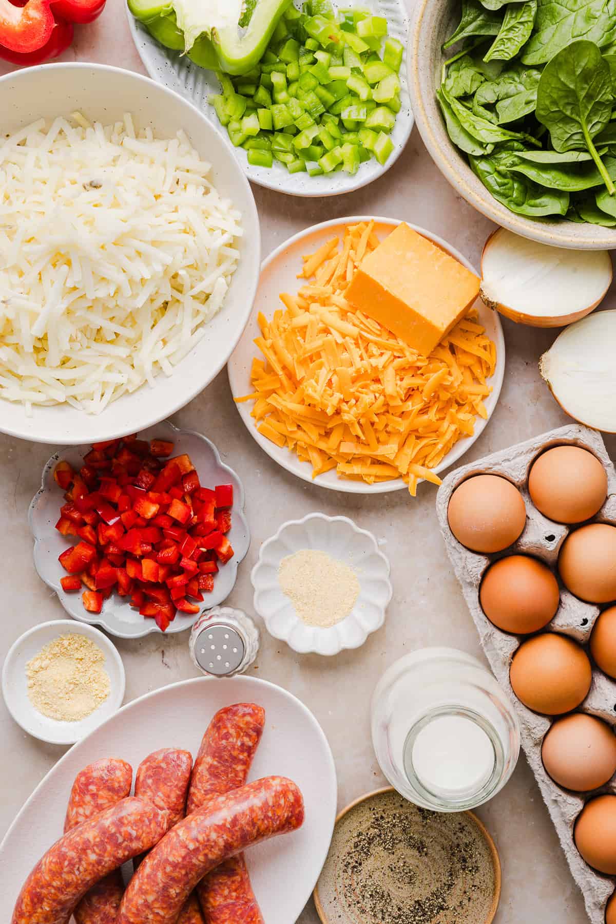 This Easy Hash Brown Breakfast Casserole is loaded with savory sausage, sautéed peppers and onions, along with melty cheese and perfectly seasoned eggs. The perfect recipe for your holiday brunch or weekend breakfast that can easily be prepped the night before!