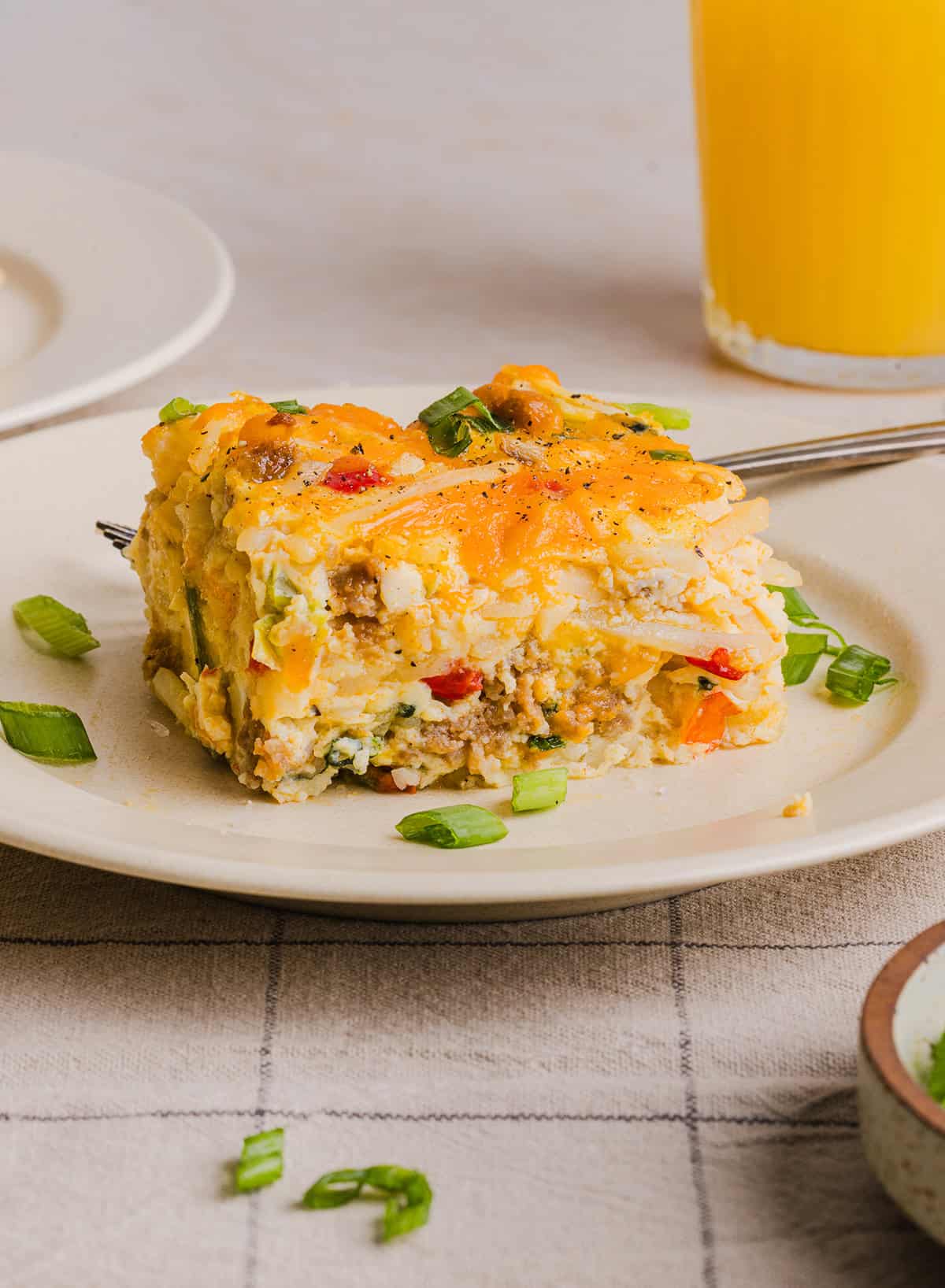 This Easy Hash Brown Breakfast Casserole is loaded with savory sausage, sautéed peppers and onions, along with melty cheese and perfectly seasoned eggs. The perfect recipe for your holiday brunch or weekend breakfast that can easily be prepped the night before!