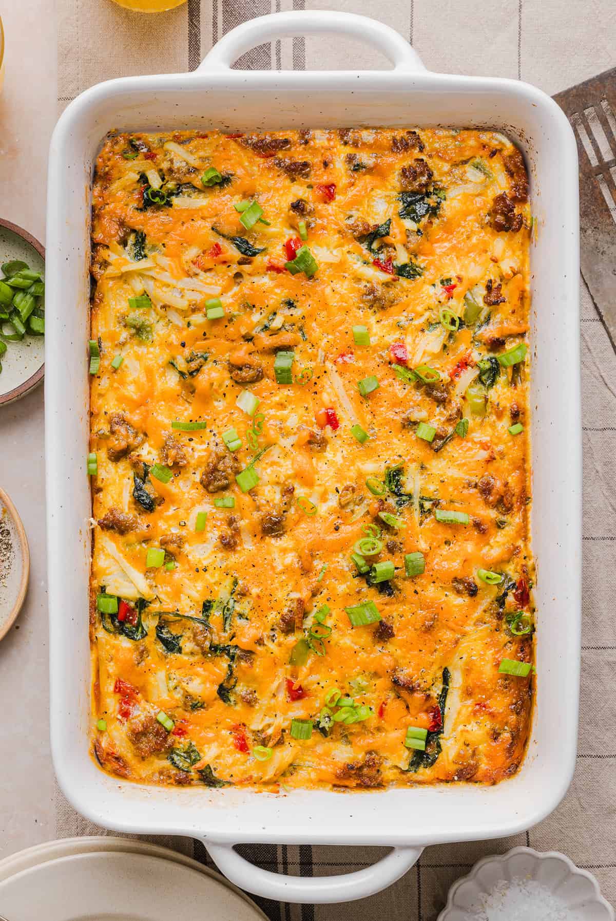 This Easy Hash Brown Breakfast Casserole is loaded with savory sausage, sautéed peppers and onions, along with melty cheese and perfectly seasoned eggs. The perfect recipe for your holiday brunch or weekend breakfast that can easily be prepped the night before!