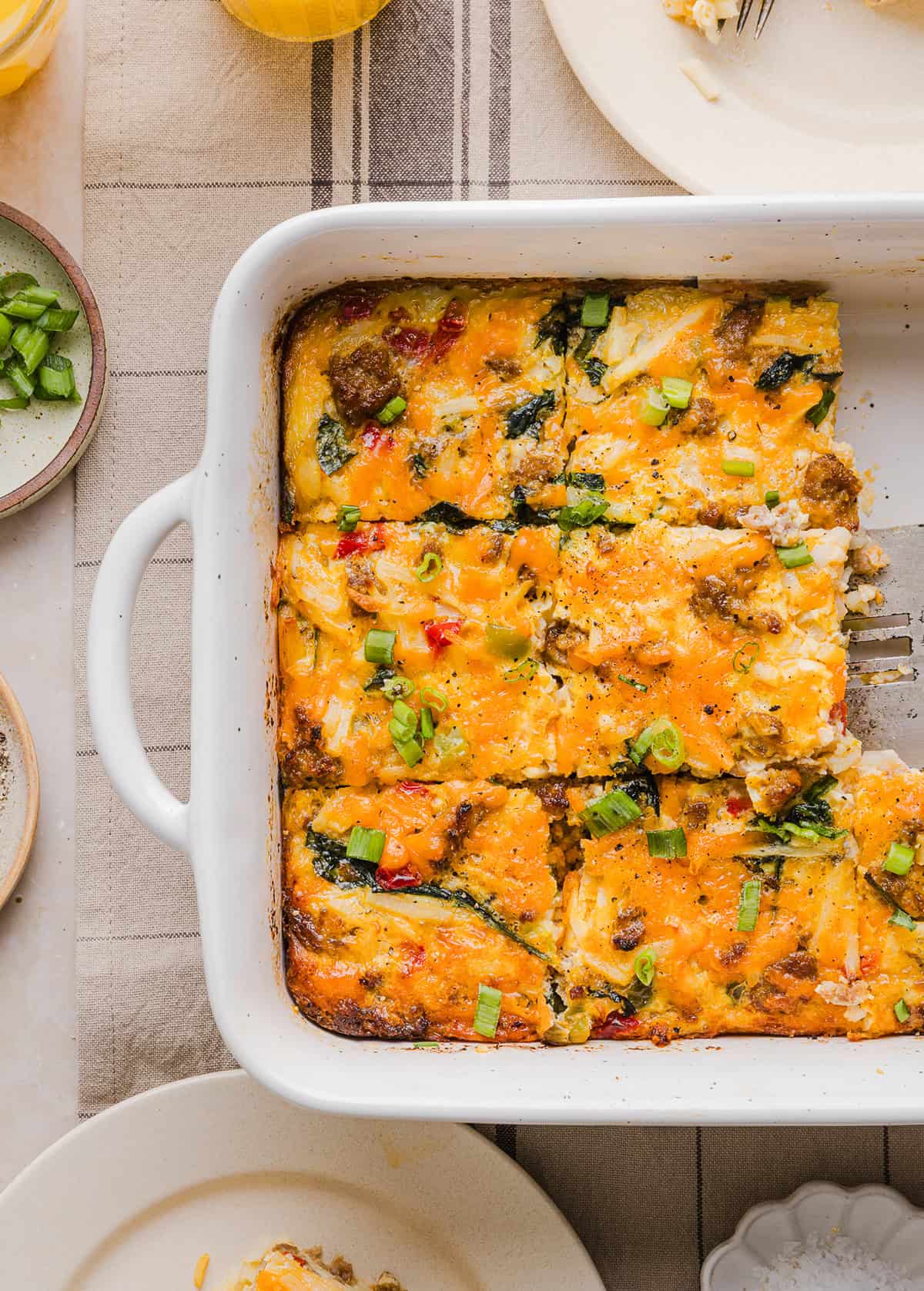 This Easy Hash Brown Breakfast Casserole is loaded with savory sausage, sautéed peppers and onions, along with melty cheese and perfectly seasoned eggs. The perfect recipe for your holiday brunch or weekend breakfast that can easily be prepped the night before!