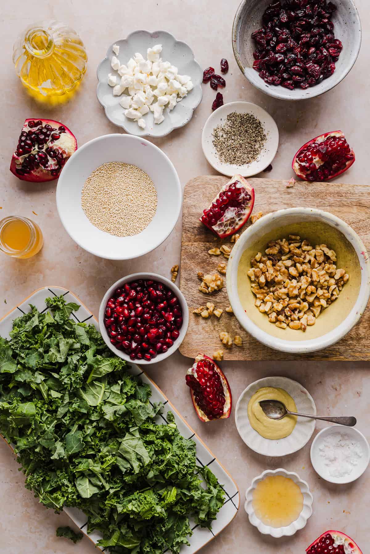 This Winter Kale and Quinoa Salad is a vibrant, wholesome salad that is bursting with flavor! Made with leafy kale, tender quinoa, juicy pomegranate seeds and crunchy walnuts all tossed together with a light dijon vinaigrette for the perfect holiday side dish!