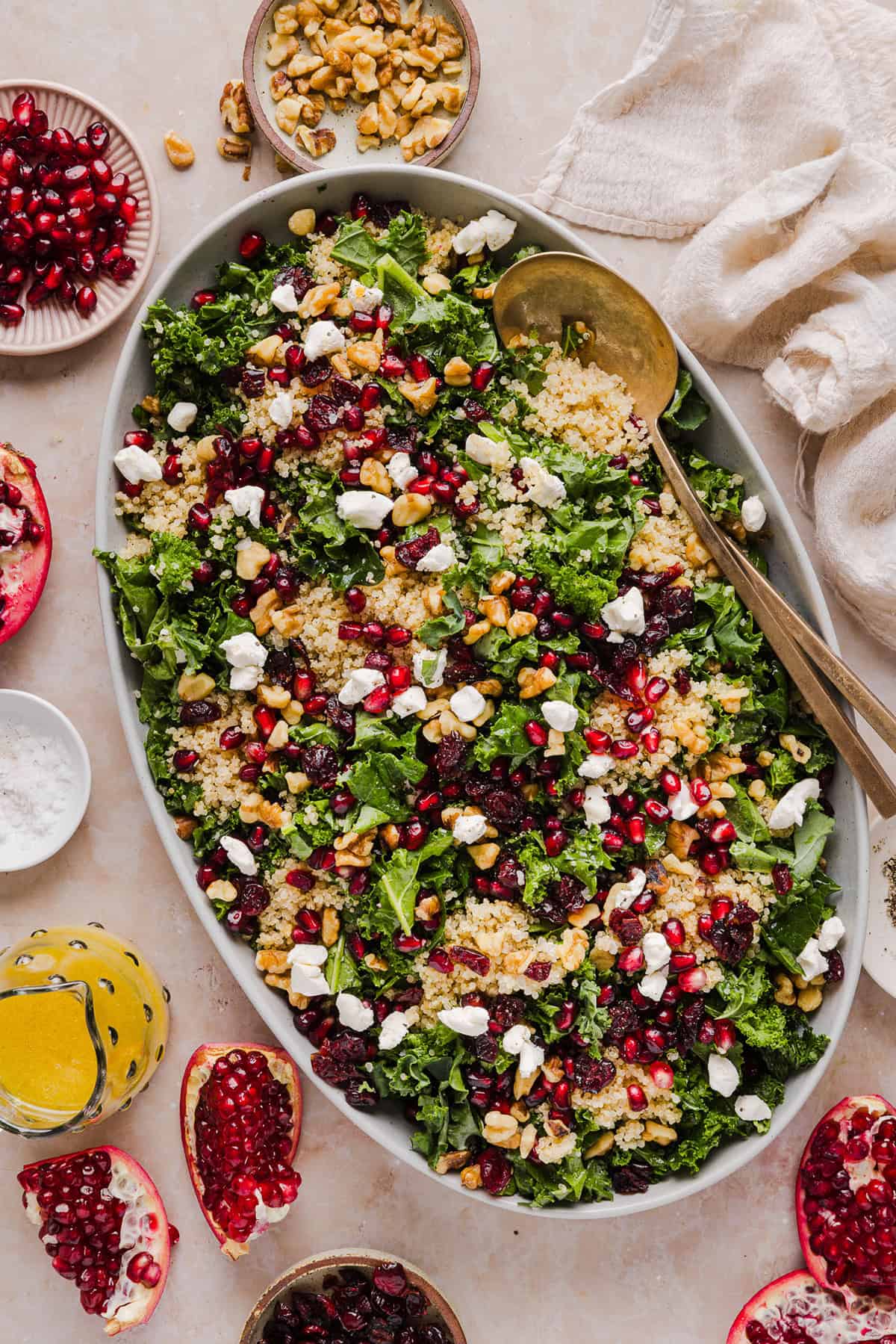 This Winter Kale and Quinoa Salad is a vibrant, wholesome salad that is bursting with flavor! Made with leafy kale, tender quinoa, juicy pomegranate seeds and crunchy walnuts all tossed together with a light dijon vinaigrette for the perfect holiday side dish!