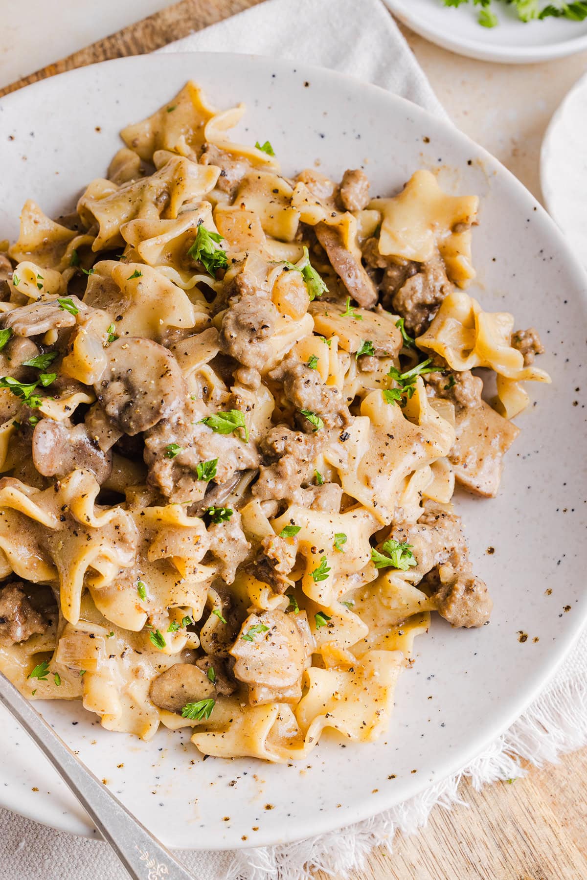 This Healthy Ground Beef Stroganoff Casserole is the ultimate family-friendly comfort food! The perfect cozy weeknight meal made with egg noodles and smothered in the most delicious creamy mushroom sauce in just 30 minutes!