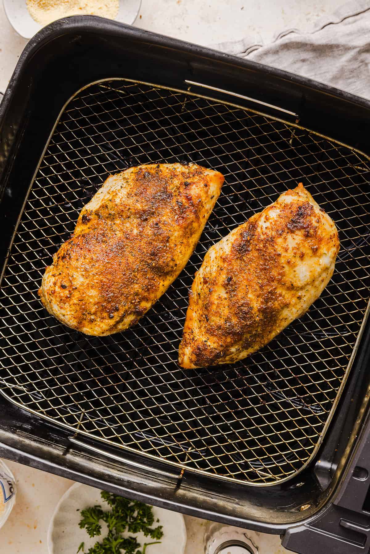 Juicy Air Fryer Chicken Breast recipe that comes out perfectly every time in just 20 minutes! Seasoned with a blend of herbs and spices for a delicious, healthy meal great for busy weeknights or when you need to meal prep.