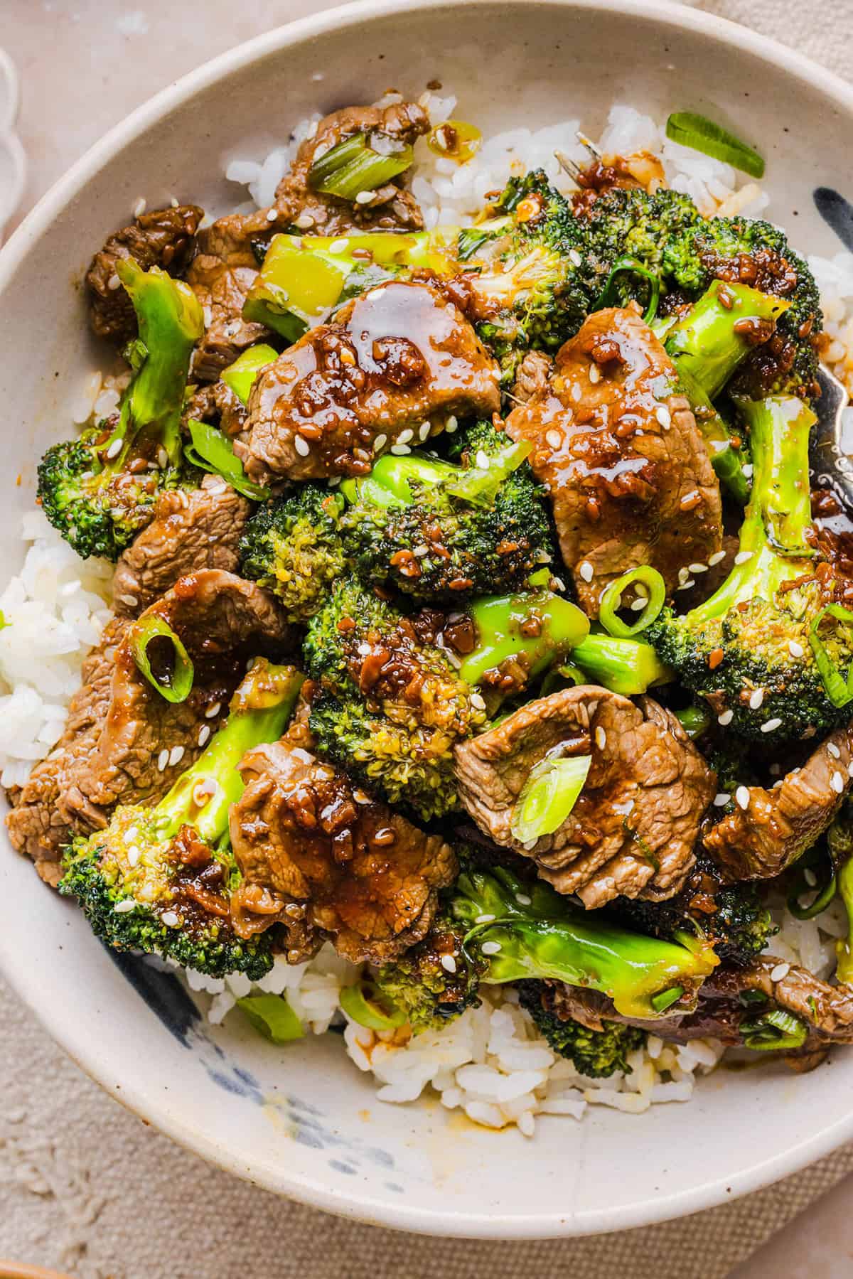 You'll love this Healthy Beef and Broccoli recipe made with tender flank steak, crisp broccoli and a savory garlic ginger sauce. A quick and easy weeknight dinner that tastes better than take-out and comes together in under 30 minutes!