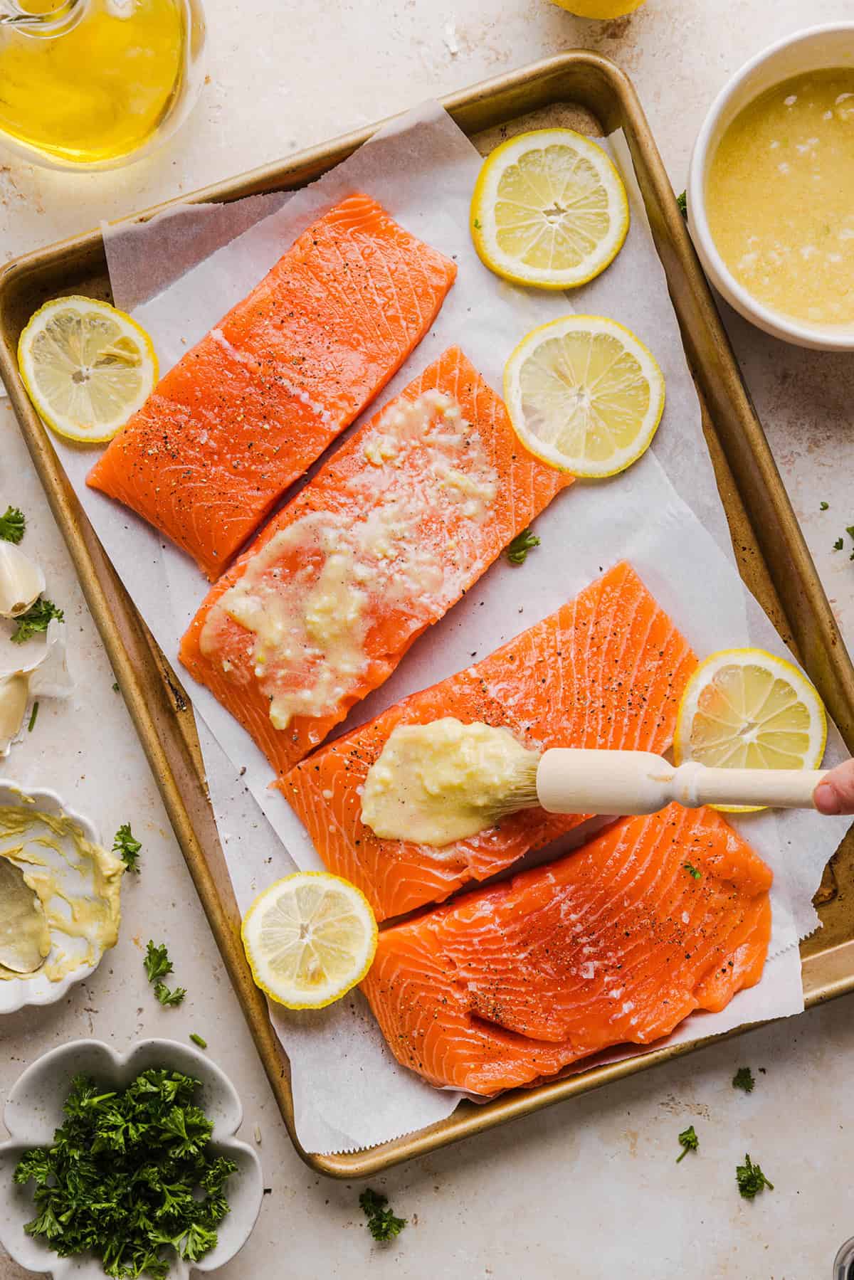 The most flavorful Garlic Butter Baked Salmon that is tender, flaky and coated in a rich garlicky sauce with lemon and Dijon. This simple healthy recipe easily comes together in under 20 minutes!