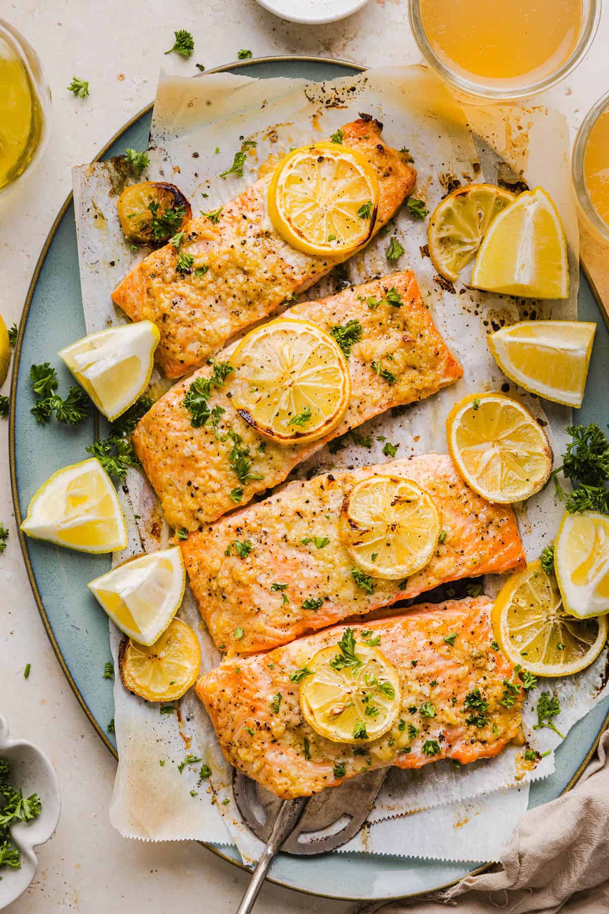 The most flavorful Garlic Butter Baked Salmon that is tender, flaky and coated in a rich garlicky sauce with lemon and Dijon. This simple healthy recipe easily comes together in under 20 minutes!