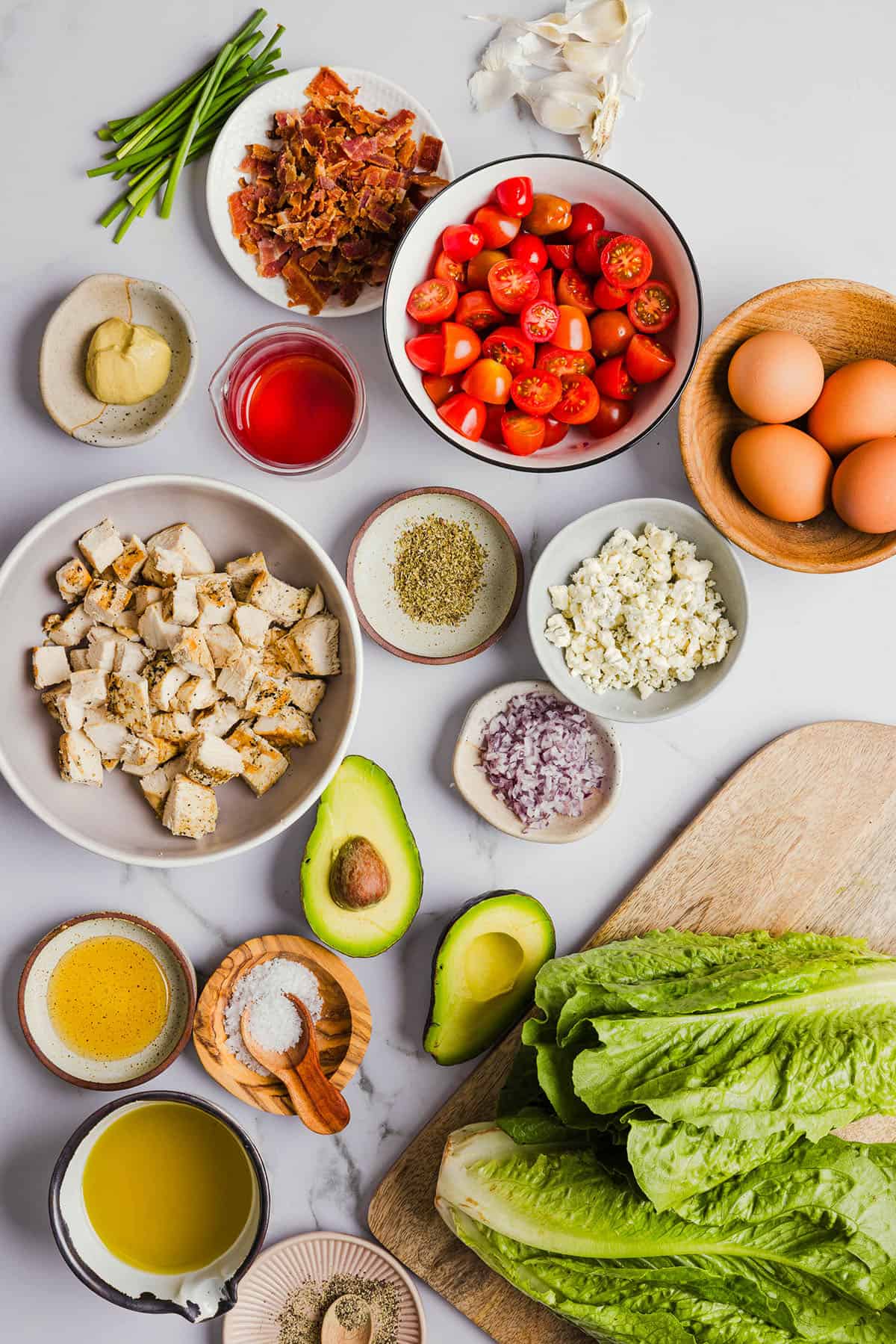 Protein-packed Chicken Cobb Salad loaded with tender chicken, crispy bacon, creamy avocado and tangy blue cheese all tossed in a delicious red wine vinaigrette! A fresh, hearty and satisfying salad that is perfect for lunch or a light dinner.