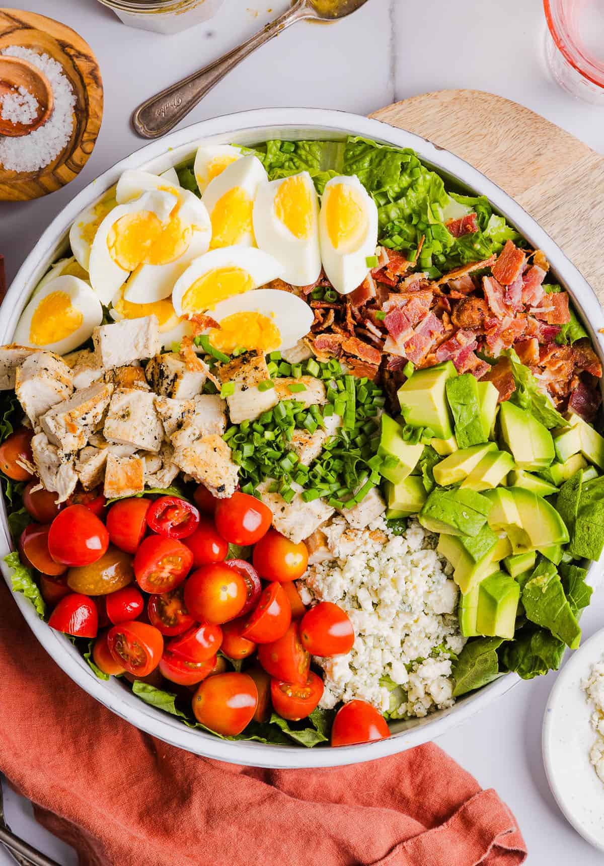This Chicken Cobb Salad is a hearty, protein-packed meal loaded with juicy chicken, crisp veggies, creamy avocado, and perfectly cooked hard-boiled eggs. A great way to use up leftover eggs and add extra flavor and richness to this easy, satisfying salad.
