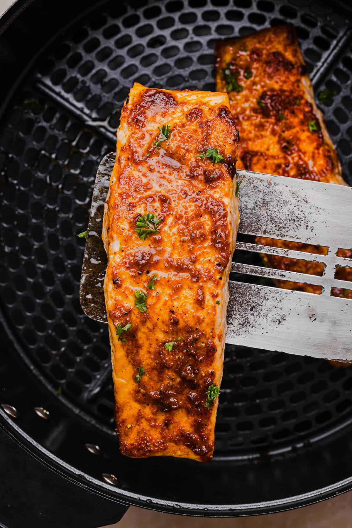 Easy Air Fryer Salmon that turns out perfectly flaky every time in under 10 minutes! Seasoned with a blend of spices for a delicious, healthy meal great for busy weeknights or when you need to meal prep.