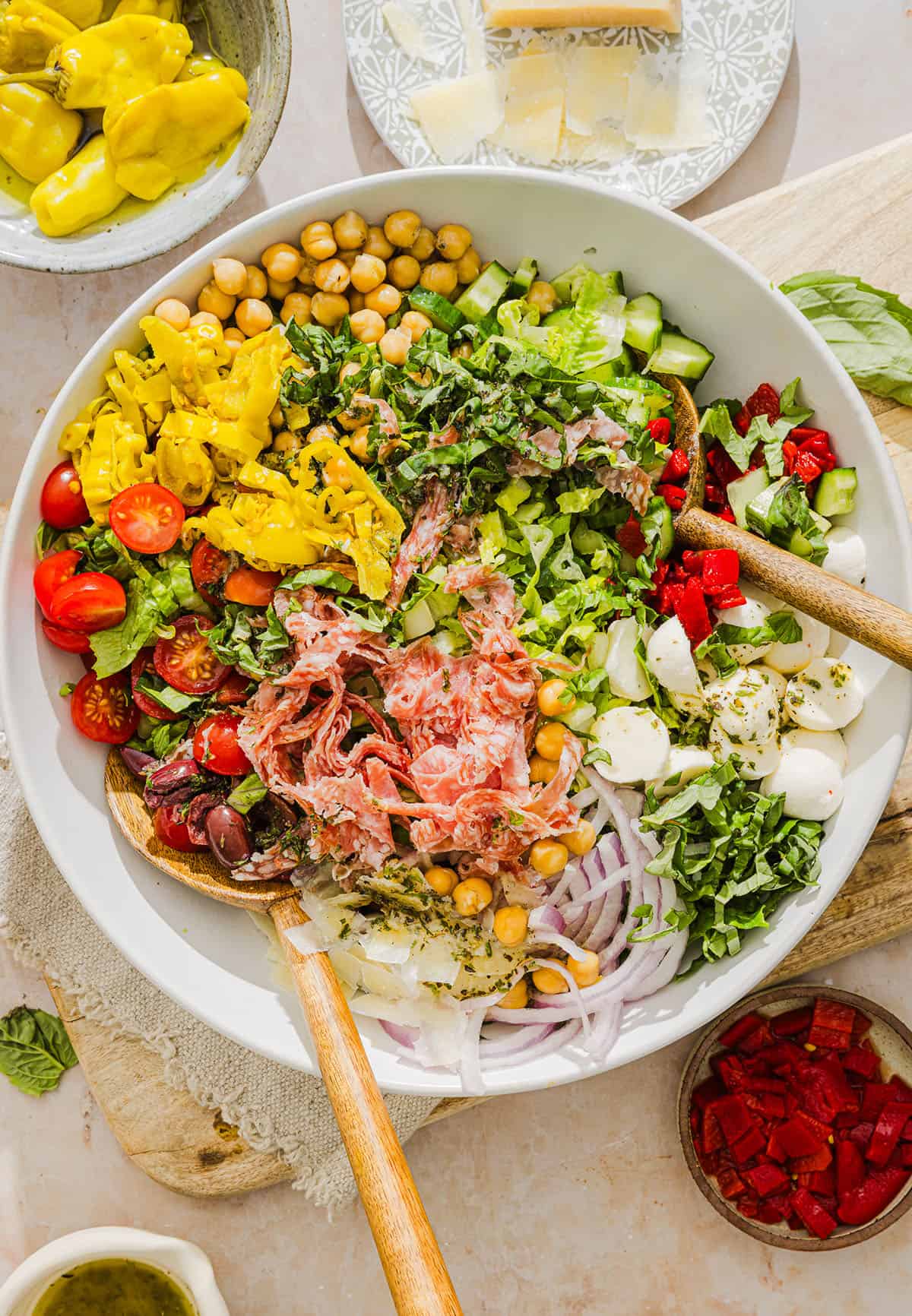 This Italian Chopped Salad tastes just like your favorite grinder, but lighter and SO good! Loaded with crisp lettuce, savory salami, chickpeas, fresh veggies and the best homemade dressing, all chopped up so you get the perfect bite every time!