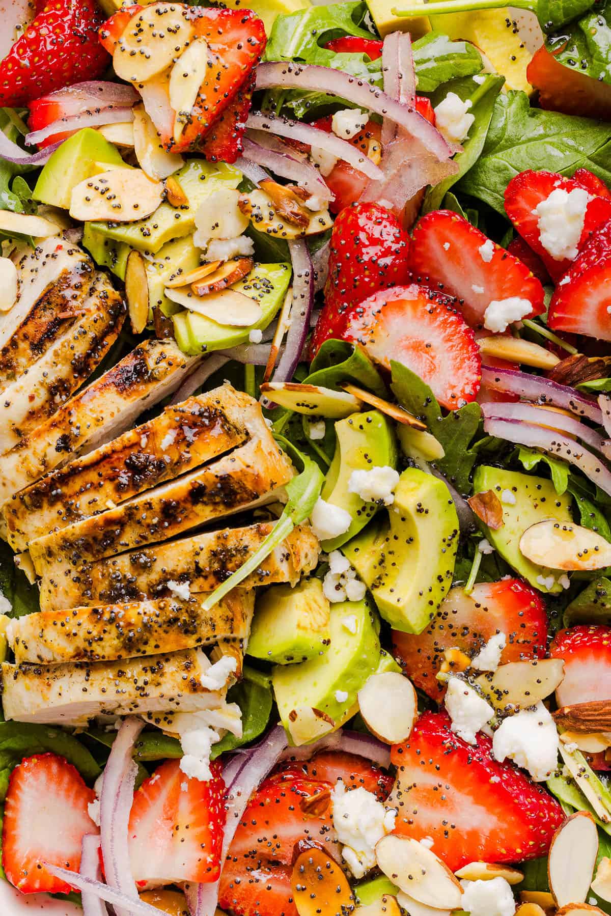 This Strawberry Poppy Seed Chicken Salad is fresh, flavorful, and perfect for spring and summer! Made with juicy strawberries, tender chicken, crunchy toppings, and the BEST poppy seed dressing.