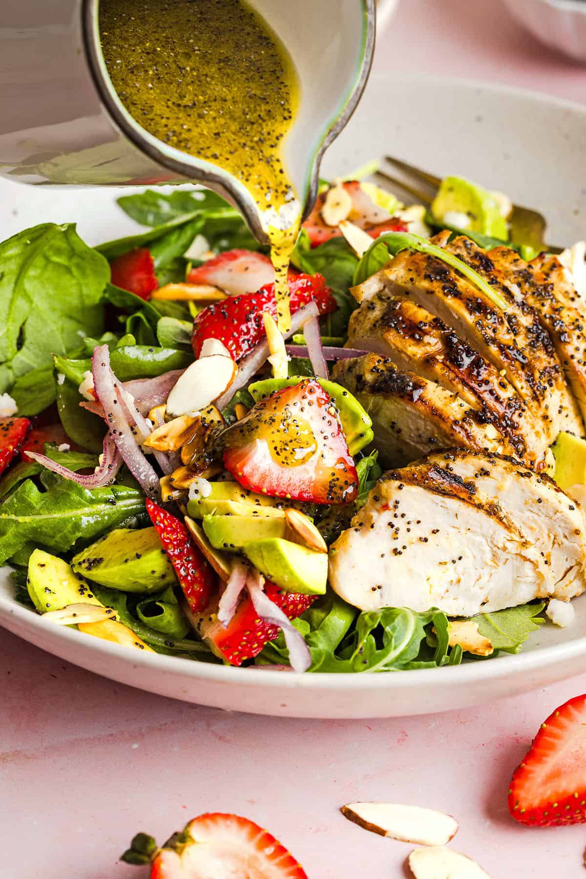 This Strawberry Poppy Seed Chicken Salad is fresh, flavorful, and perfect for spring and summer! Made with juicy strawberries, tender chicken, crunchy toppings, and the BEST poppy seed dressing.